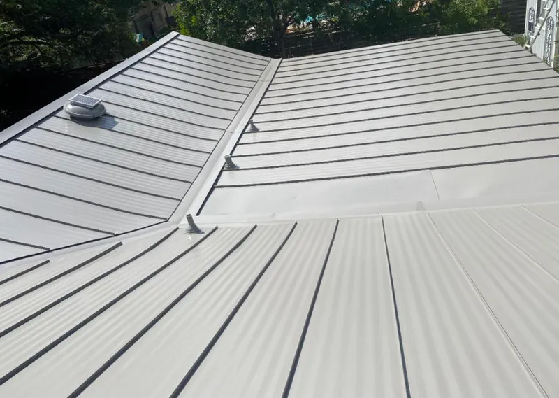 Solar attic fan installed on a metal roof for Roof Ventilation in Beach Park